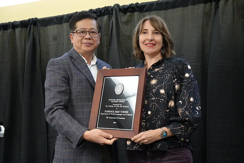 Florence Abad-Turner is presented an award by Liem Tran at the 2023 Faculty Awards Convocation